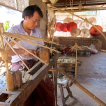 An artisan carves the frame for their homemade paper parasols near the Myin Ma Hti Cave